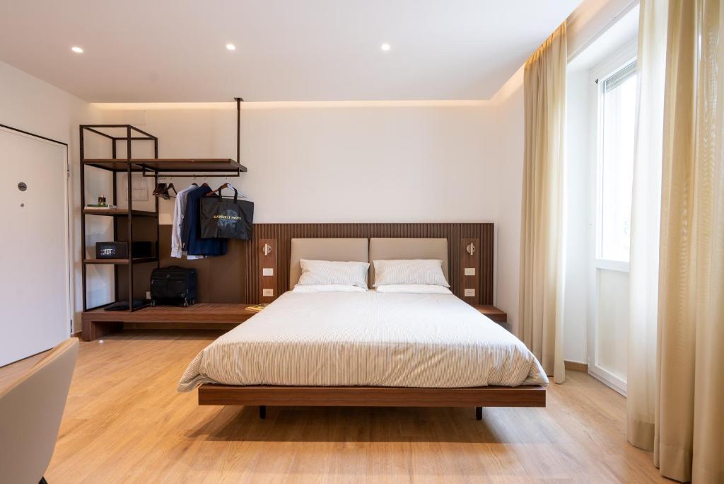 a bedroom with a large bed and a large window at Dante Suites in Pergola
