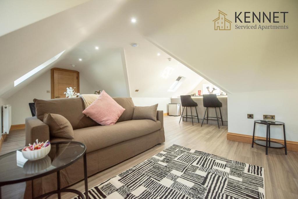 a living room with a couch and a table at Hazel Lodge in Reading