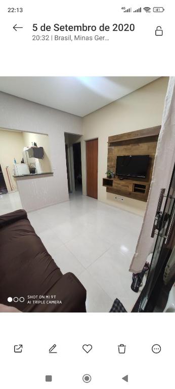 a picture of a living room with a couch and a tv at Casa Oliveira in Montes Claros