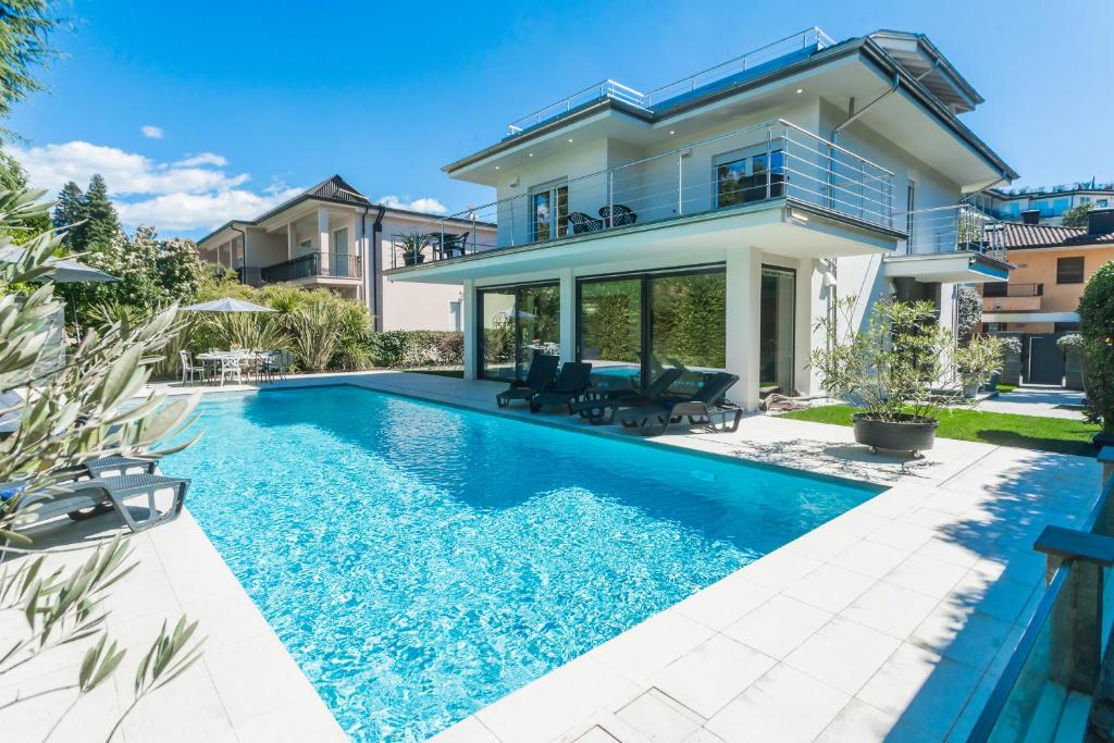 a house with a swimming pool in front of a house at Villa Chiara in Stresa