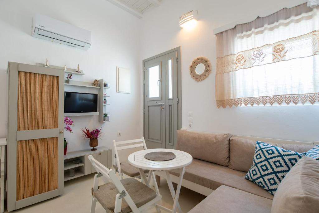 a living room with a couch and a table at Anna's Apartment Marmara Paros in Kampos Paros