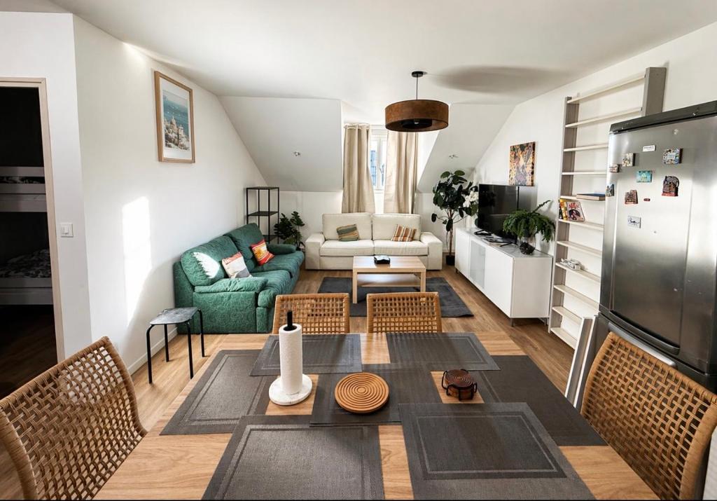 a living room with a couch and a table at Appartement St denis in Saint-Denis