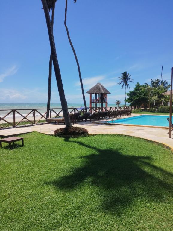 a resort with a pool and a gazebo next to the ocean at Eco Paradise 228 in Cumbuco