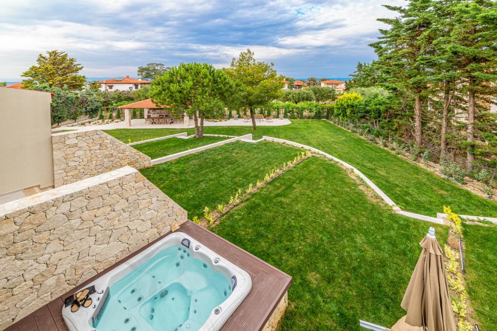 an aerial view of a backyard with a hot tub at Pelagus Luxury Villas in Polychrono