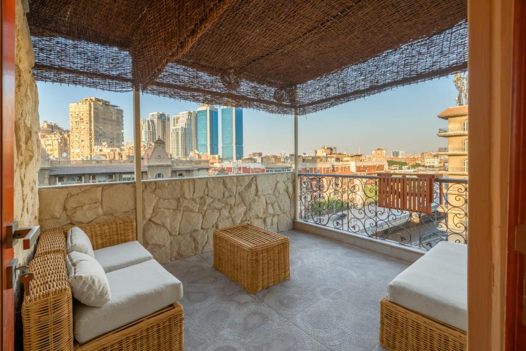 a room with a balcony with a view of the city at M-Residence By Brassbell in Cairo
