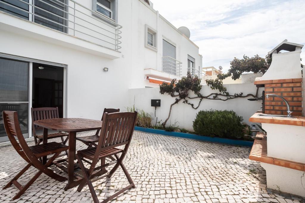 a table and chairs on the patio of a house at Montesol by ALGARVEMANTA in Manta Rota
