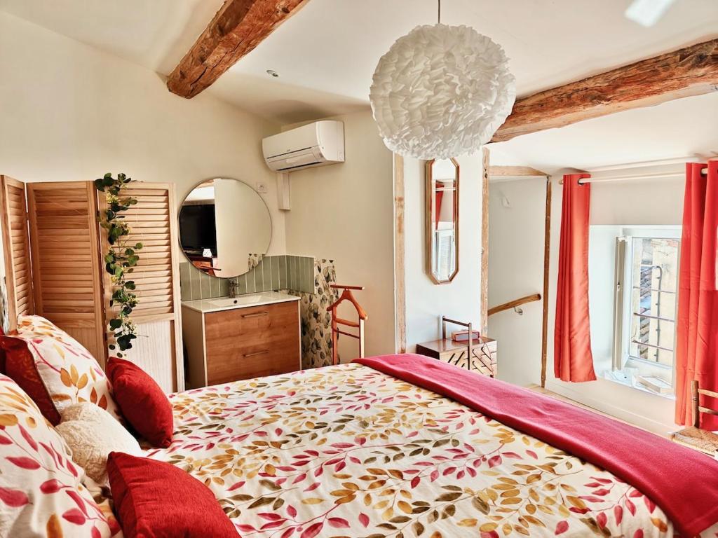 a bedroom with a large bed and a mirror at entre vignes et canal in Azille