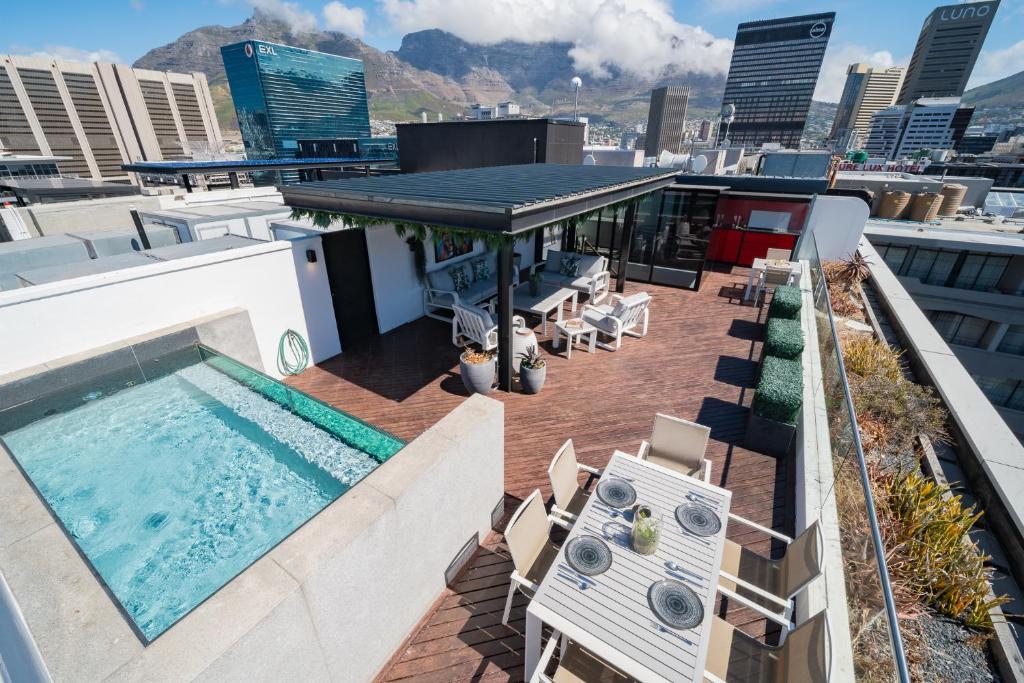 a rooftop deck with a swimming pool on a building at Crayfish Penthouse - The Onyx Cape Town in Cape Town