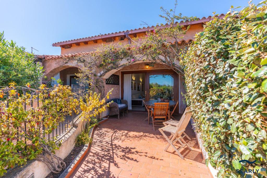 a patio of a house with an ivy covered fence at Casa Solea in Olbia