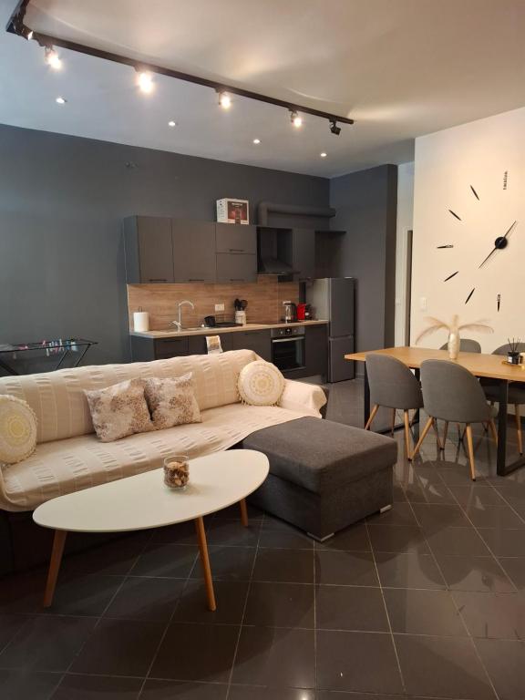 a living room with a couch and a table and a kitchen at KATHRIN APPARTS in Alepou