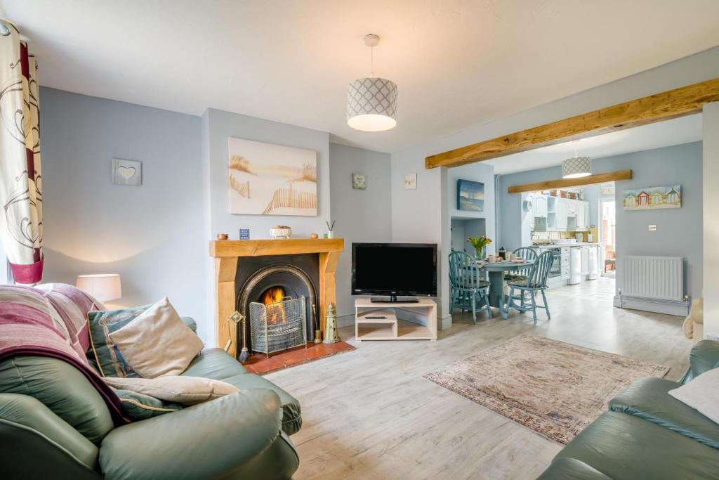 a living room with a couch and a fireplace at 2 Bed in Heacham oc-p29546 in Heacham