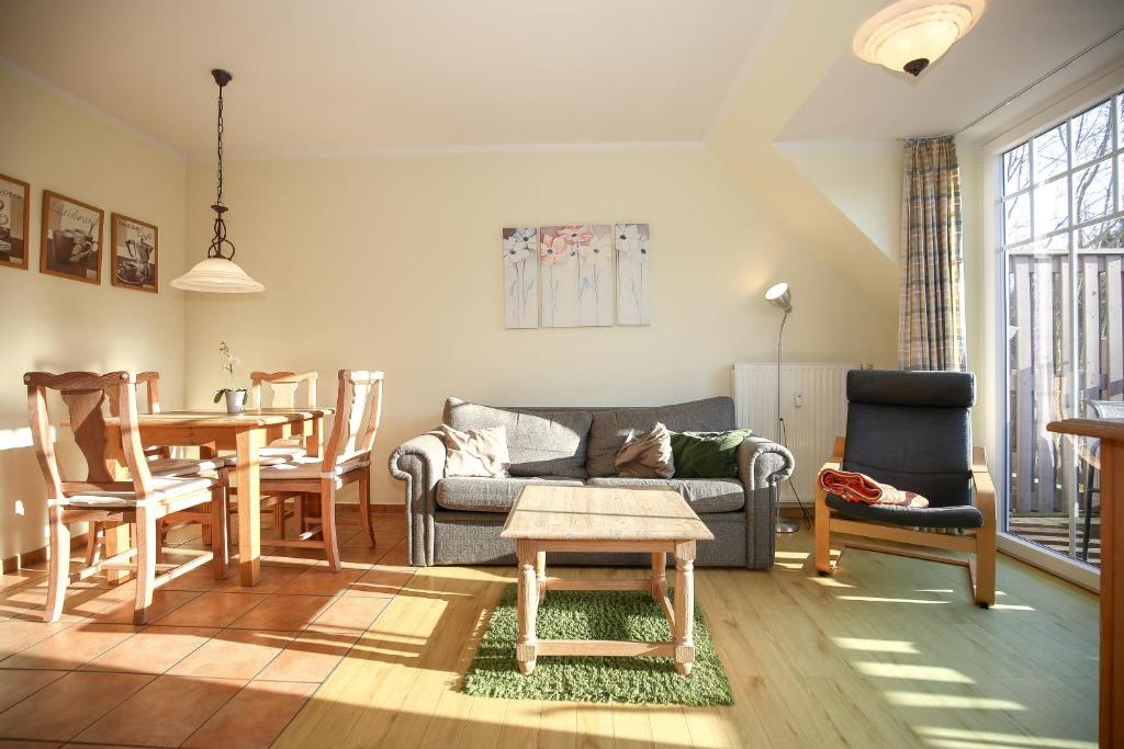a living room with a couch and a table at Ostseewelle Wohnung 24 in Kühlungsborn