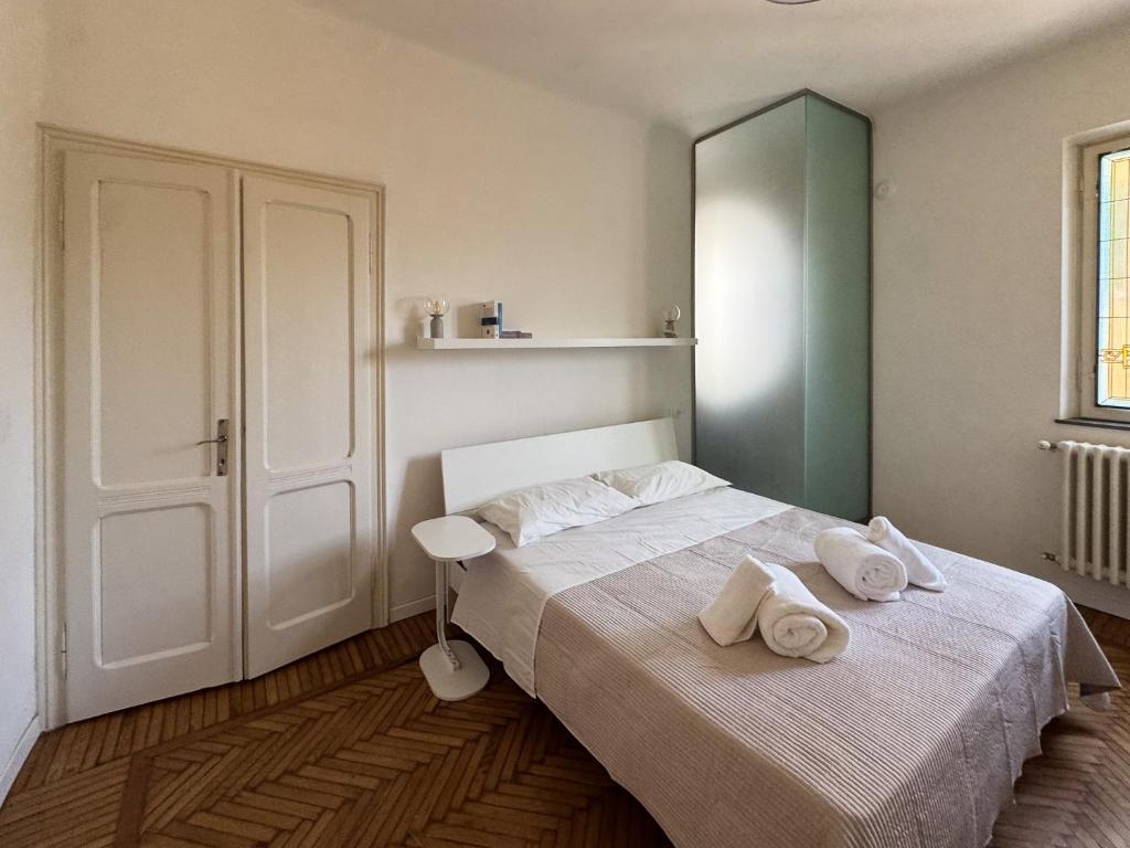 a bedroom with a bed with two towels on it at René Apartments in Salsomaggiore Terme