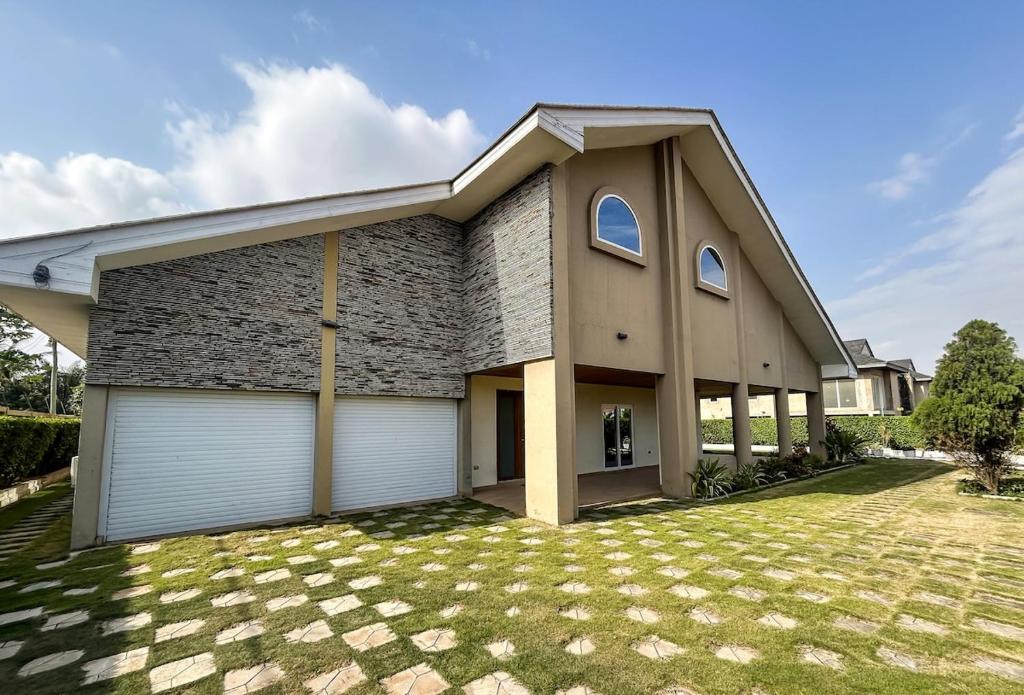a large brick house with a garage at Ivory's Nest in Accra