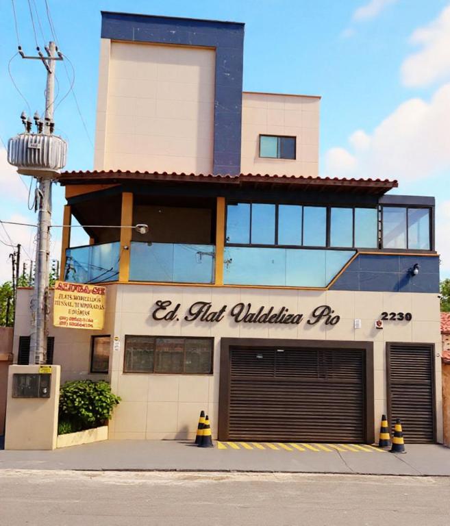 a building with a parking garage in front of it at Ed Flat Valdeliza Pio in Teresina