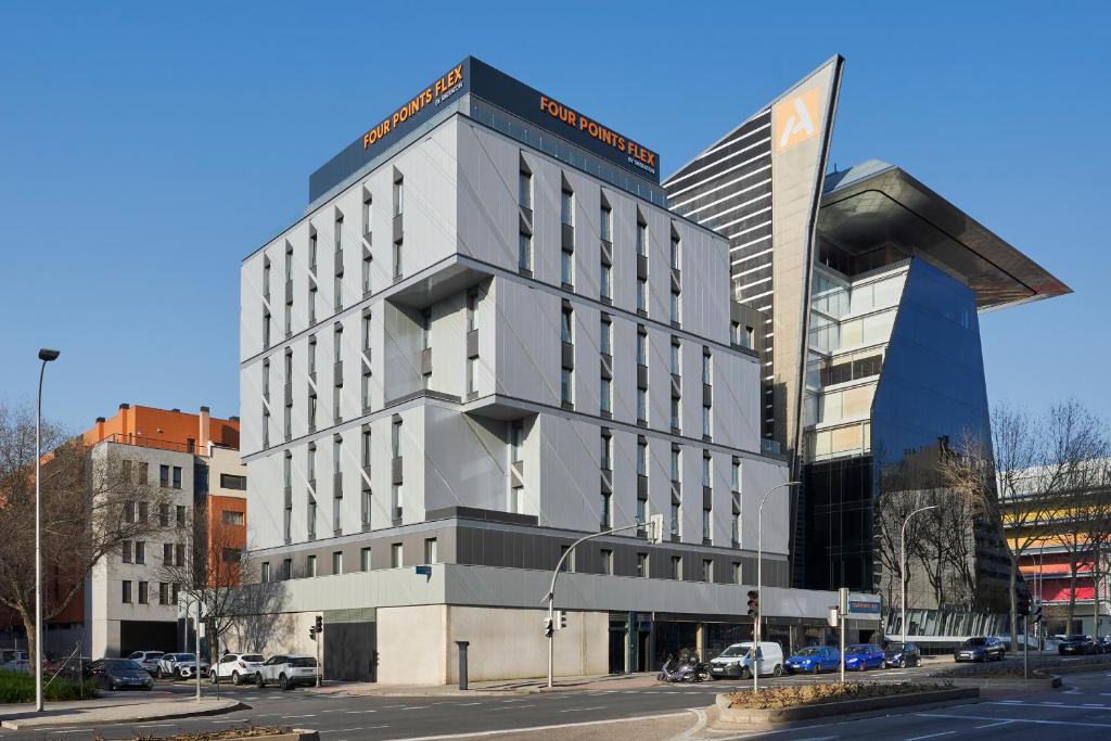 a tall building on a city street with at Four Points Flex by Sheraton Madrid Atocha in Madrid
