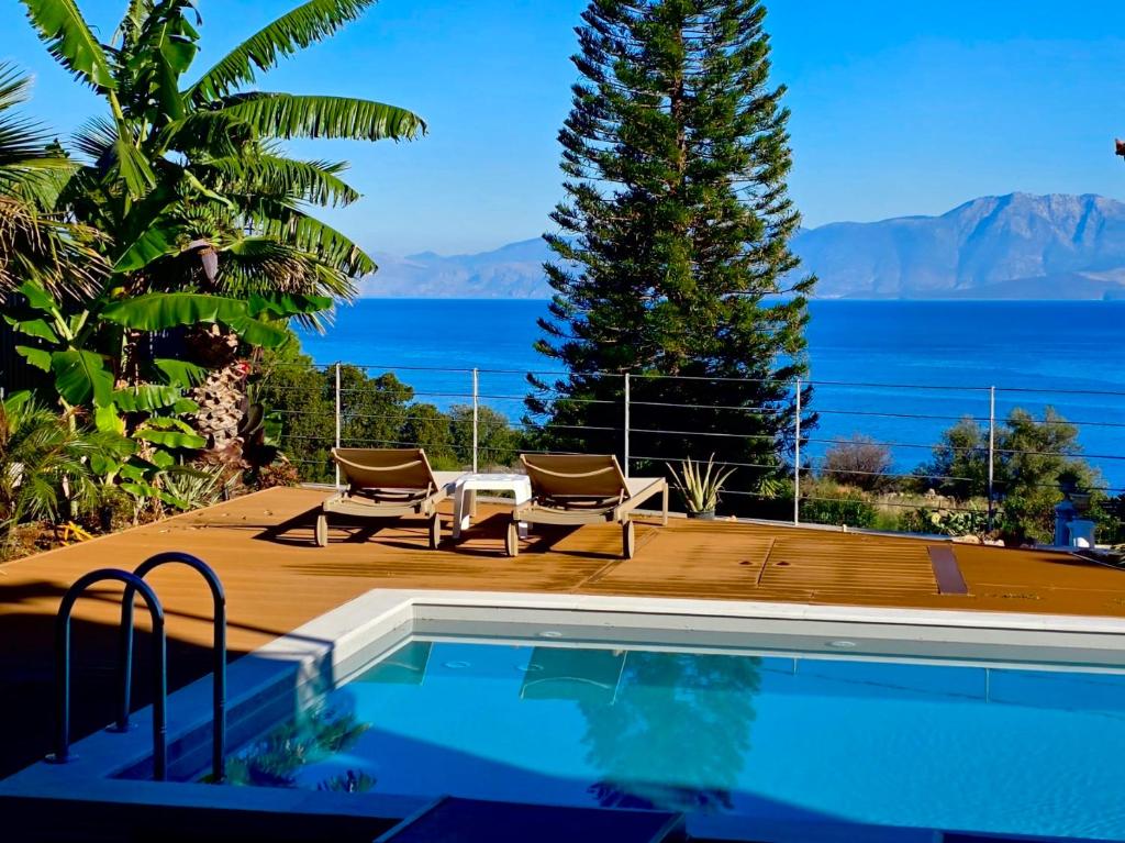 a swimming pool with a view of the water at Rastoni Sea View Studio with Shared Pool in Melíssion