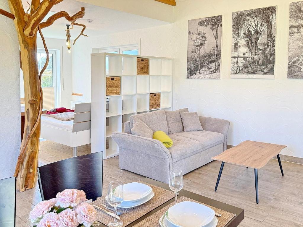 a living room with a couch and a table at Eichengrund Baum 7 in Burg