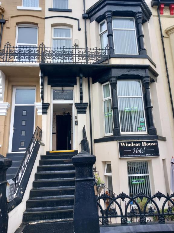 a building with stairs leading up to the front door at Windsor House Hotel in Blackpool