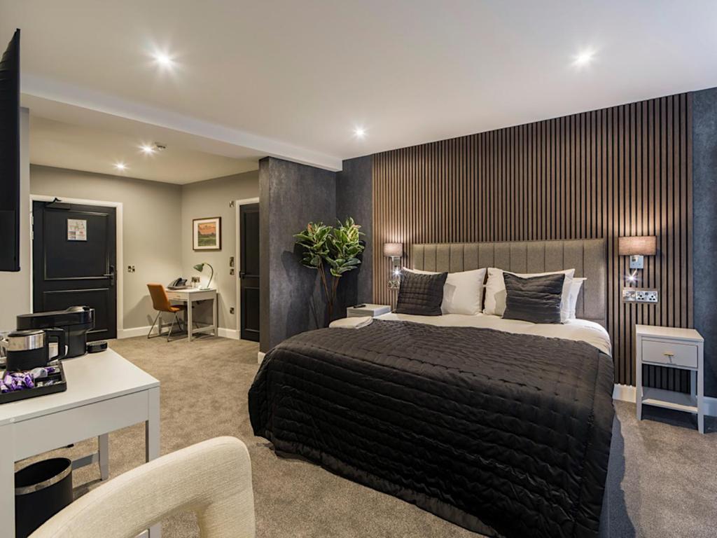a bedroom with a large bed and a desk at Hotel 30 Five in Aberdeen