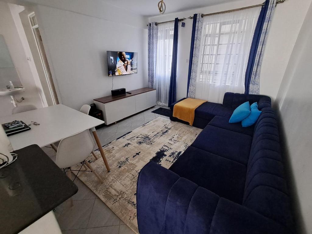 a living room with a blue couch and a table at Parma Staycation in Rungiri