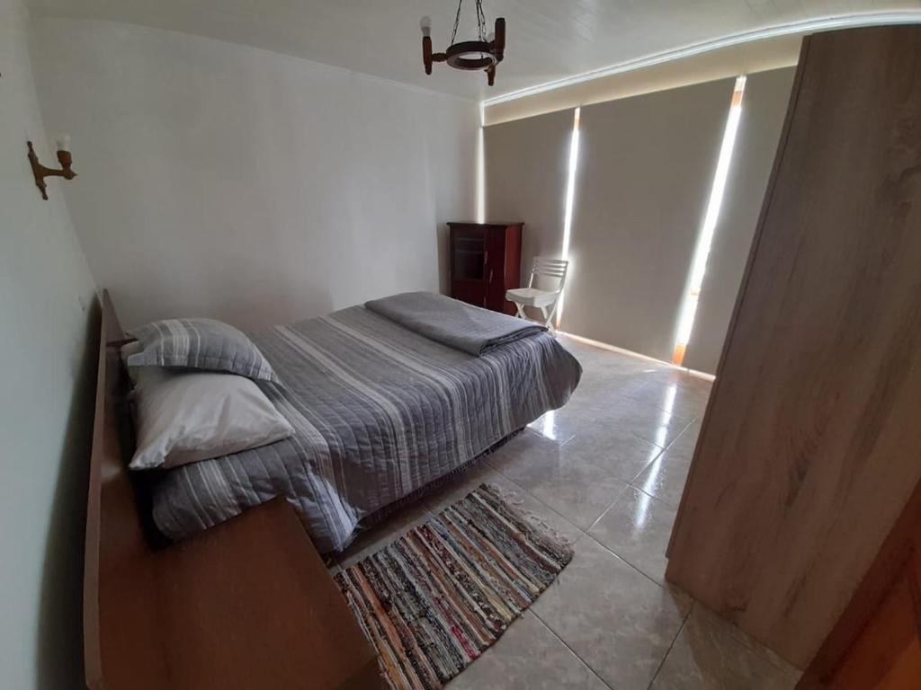 a bedroom with a bed with a rug in it at Tongoy península in Coquimbo