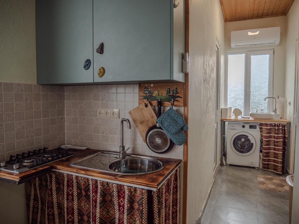 a kitchen with a sink and a washing machine at kutaisi base camp in Kutaisi