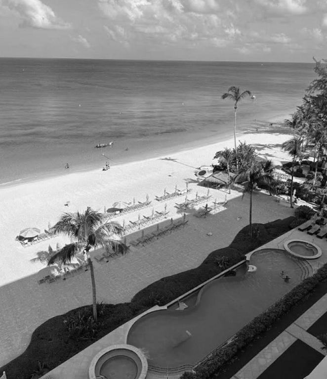 a black and white photo of a beach with a pool at Apartment with Exclusive Amenities in George Town