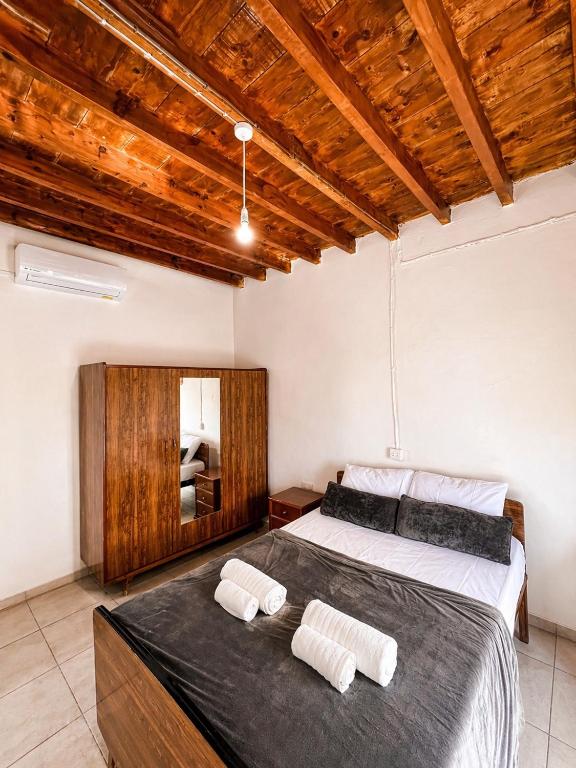 a bedroom with a large bed with two towels on it at Peyia traditional house in Paphos