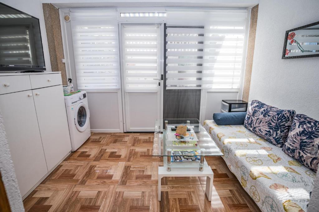 a living room with a couch and a table at MA-LO 1 in Pirovac