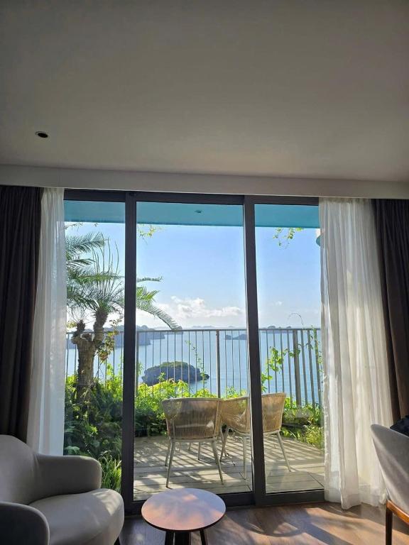 a living room with a view of the ocean at Flamingo Cát Bà in Cat Ba