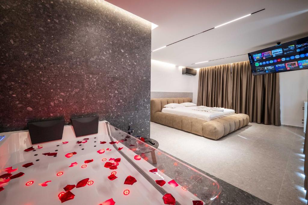 a room with a bed and a table with roses on it at Euphoria Apartments in Sarandë