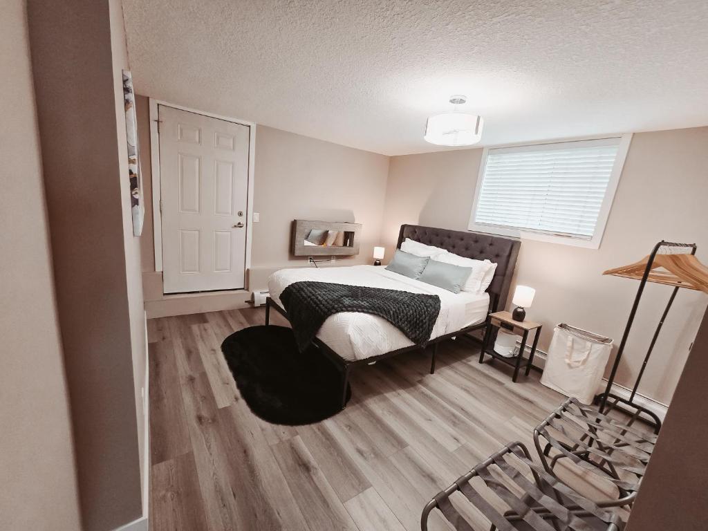 a small bedroom with a bed and a window at Riverfront Condo - Free Parking, Walk DT, Sleep 4 in Calgary