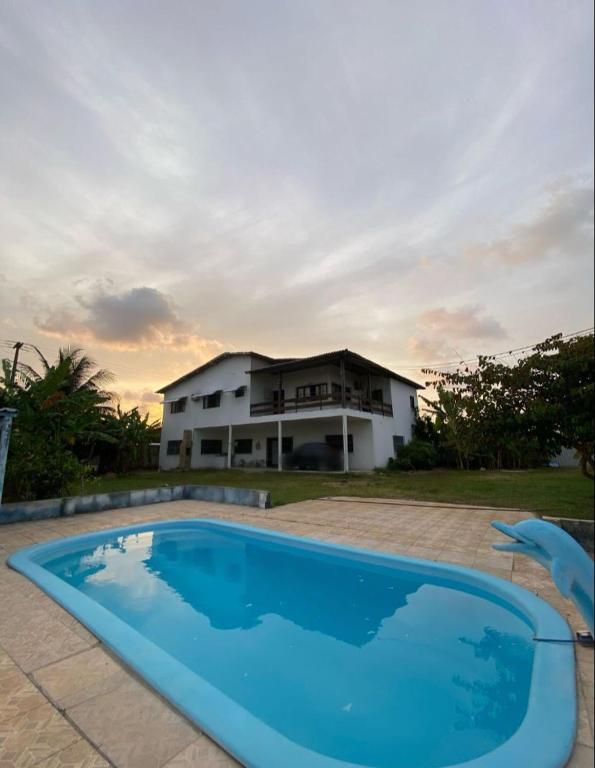 a house with a blue swimming pool in front of a house at Casa completa, Praia e Rio in Extremóz
