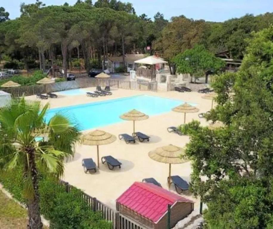 an overhead view of a pool with umbrellas and chairs at Cottage PARKS DI LICCIA in Bonifacio
