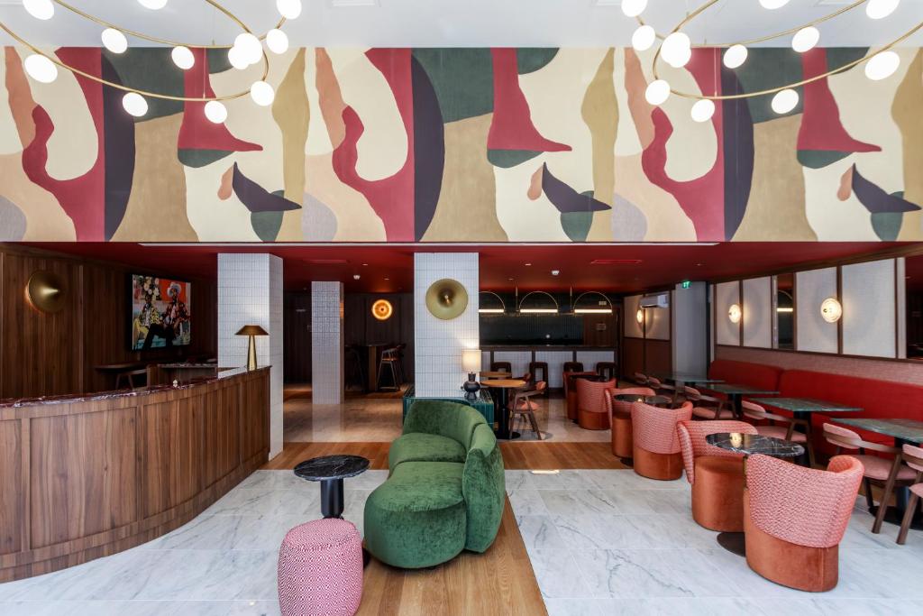 a lobby with colorful chairs and tables in a restaurant at Casa Falcão Boutique Hotel by Aspasios in Porto