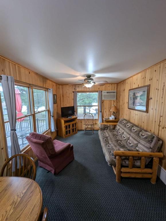 a living room with a couch and a table at 2BR 1BA Cabin #7 Riverside Point Resort in Park Rapids