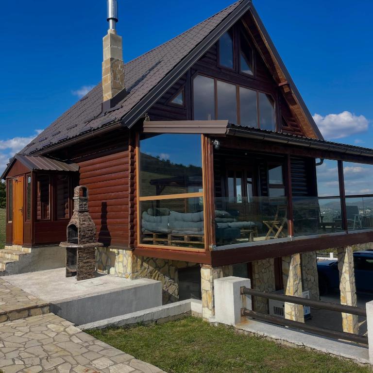 a house with large glass windows and a roof at Zlatibor Sky Inn in Zlatibor
