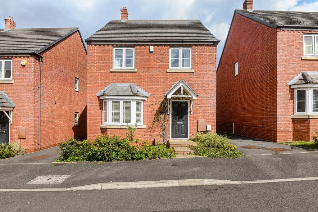 a red brick house with a door on a street at 4BD Spacious detached House in Birmingham suitable for Contractors and family's with free parking on private drive sleeps 9 in Birmingham