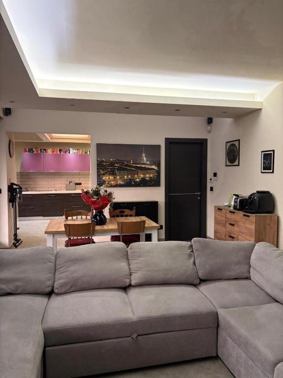 a living room with a couch and a table at La casa nel parco in Chieri