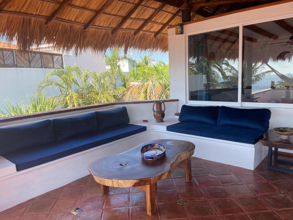a living room with a blue couch and a table at Penthouse Bella Vista in Puerto Escondido