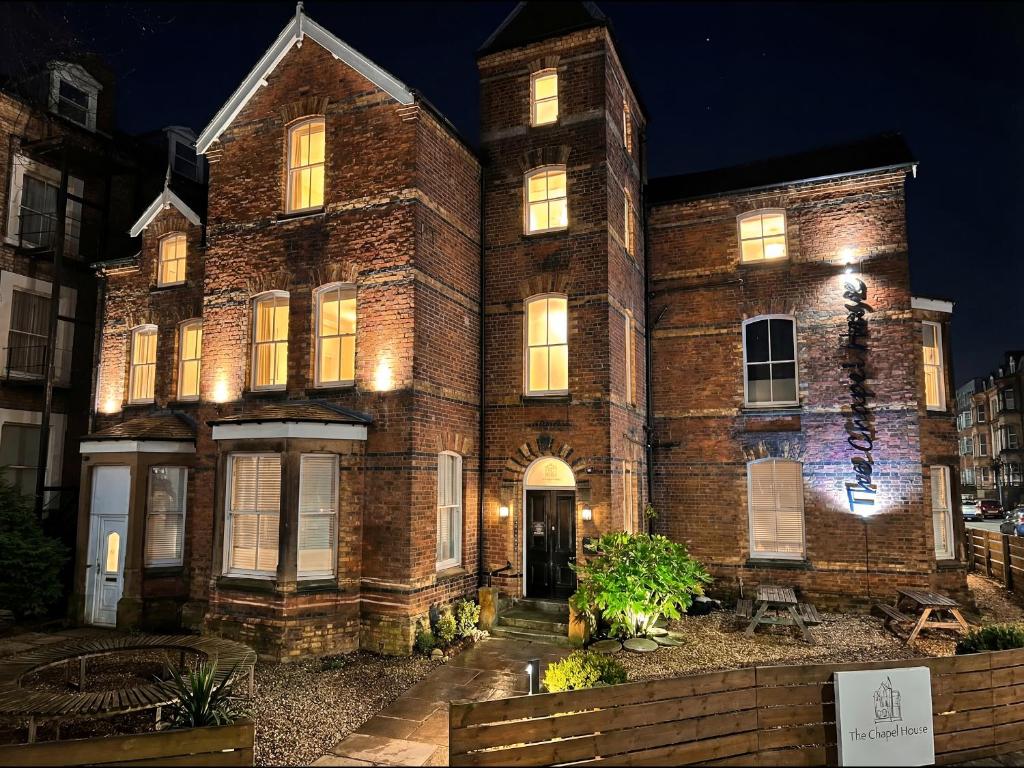 an old brick building with lights on it at night at Craven Suite in Scarborough