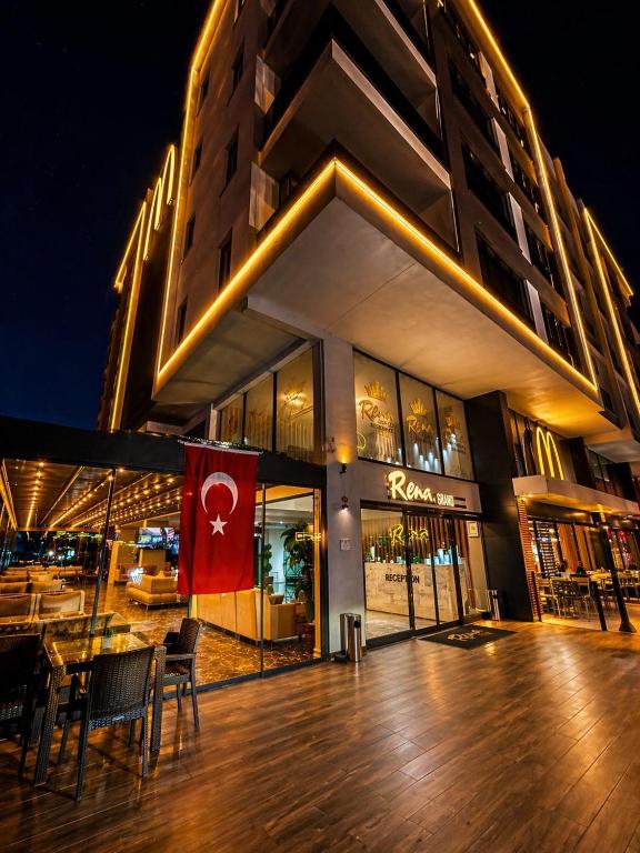 a building with a flag in front of it at Rena Grand Residence & Suit in Trabzon