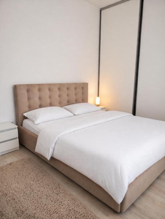 a bedroom with a large bed with a large headboard at Sibiu Edge Retreat in Sibiu