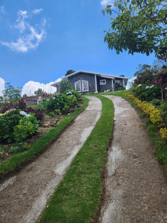 a dirt road in front of a house at Hideout by Cloudwalks in Kodaikānāl