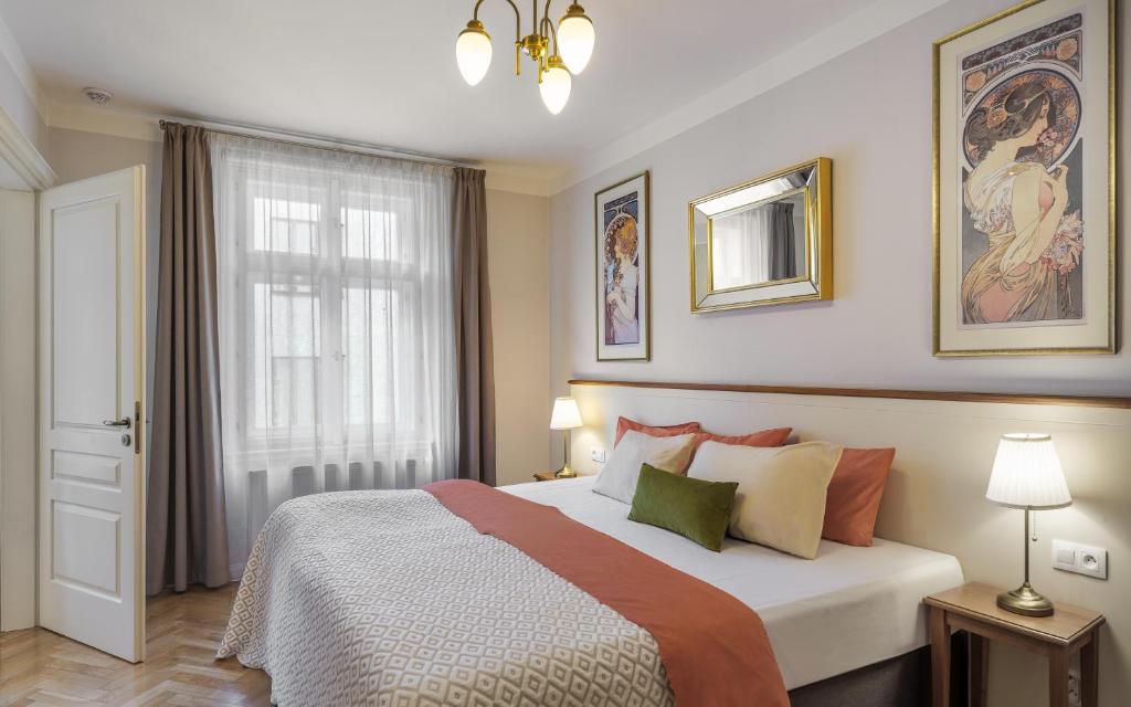 a bedroom with a large bed and a window at SeNo6 Apartments in Prague