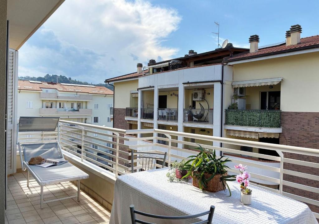 a balcony with a table and chairs on a building at Holihome Hill View in Tortoreto Lido