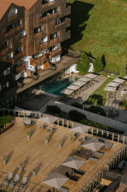 an aerial view of a building with a swimming pool at Hotel Cristal in Obereggen