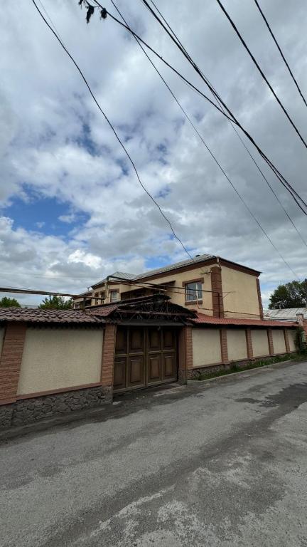 an old building on the side of a street at Aruzhan Hostel in Shymkent