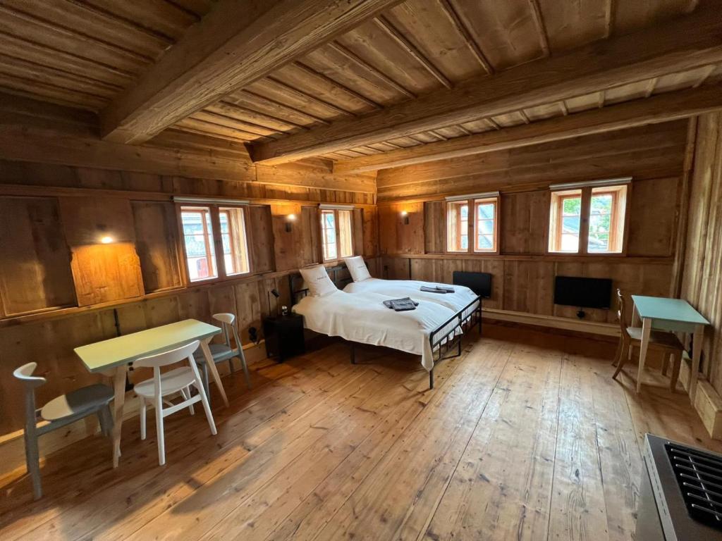 a bedroom with a bed in a room with wooden walls at Faktorei 312 in Eibau